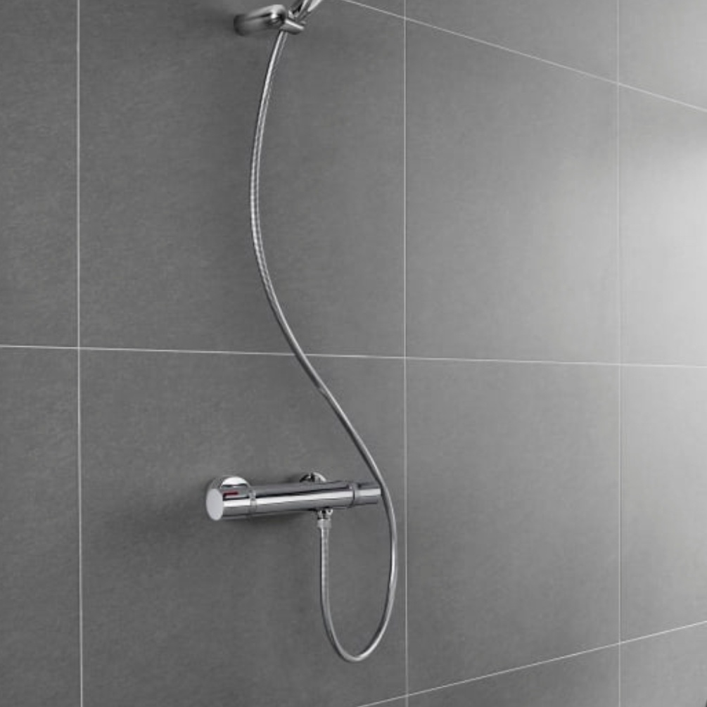 Lifestyle image of the Roca Flex Chrome 1500mm Anti-Twist Shower Hose connected to a shower head and outlet